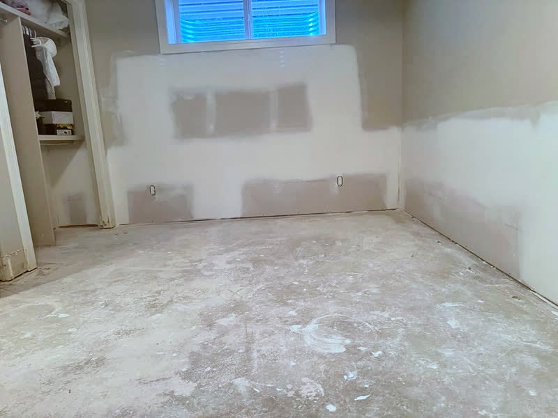 Basement bedroom walls taped and mudded, ready for sanding