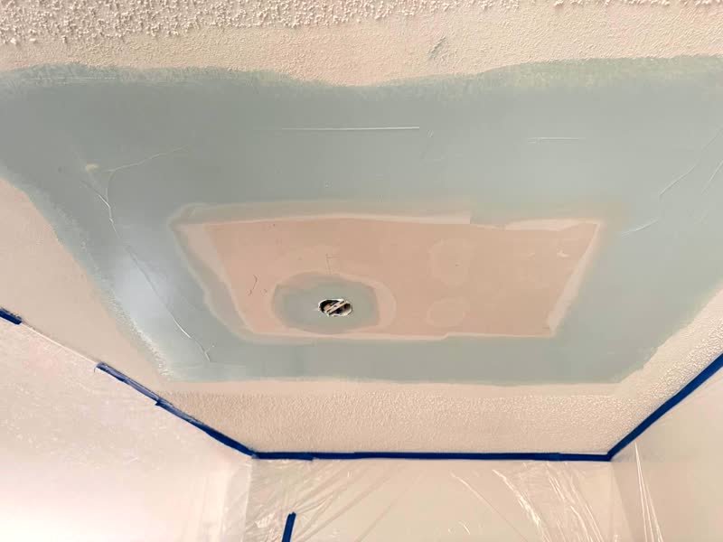 Ceiling patch taped and covered in joint compound