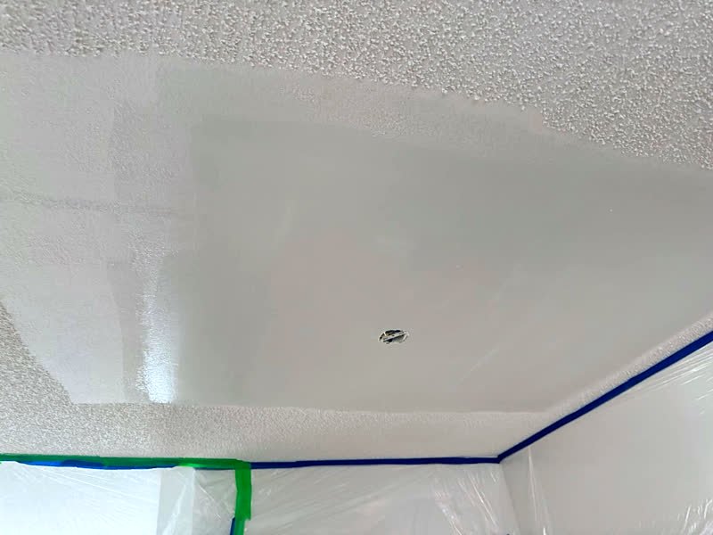 Popcorn ceiling texture being matched over a repaired area